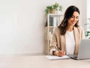 Business administration professional working on a laptop in a modern home office